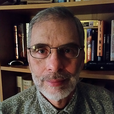 man with short hair, glasses, and a beard