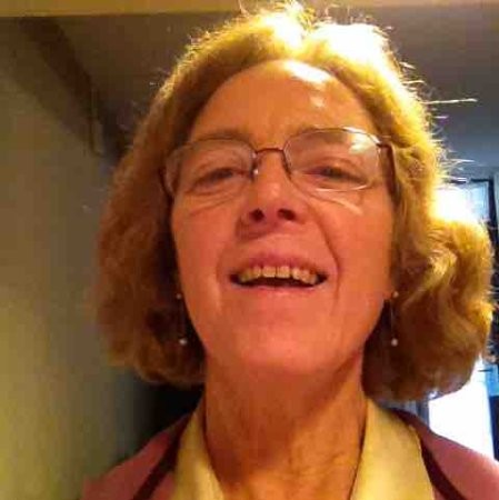 woman with short blonde hair and glasses